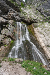 Huge waterfall flowing from the cliff. Abkhazia