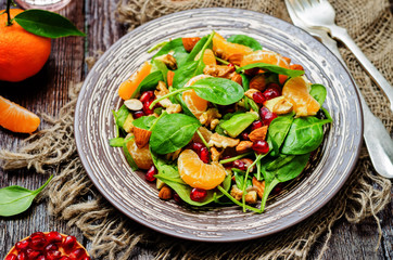 Spinach tangerines pomegranate avocado almonds walnuts salad