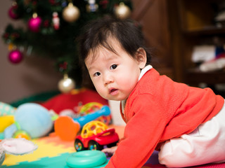 Obraz premium Asian baby girl playing toy in home