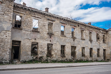 War damaged building against cloudy sky