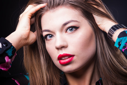 young beautiful woman with red lips and makeup