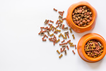 dry dog food in bowl on white background top view