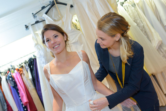 bride-to-be trying on wedding dress at a dress fitting