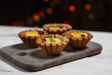 Homemade desserts with fruits for the new year. Desserts for the holidays. Side view. Against dereeva and trees. Beautiful background.