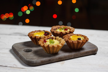 Homemade desserts with fruits for the new year. Desserts for the holidays. Side view. Against dereeva and trees. Beautiful background.