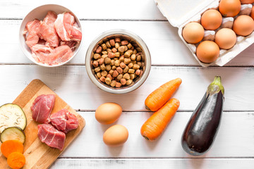 ingredients for pet food holistic top view on wooden background