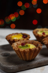 Homemade desserts with fruits for the new year. Desserts for the holidays. Side view. Against dereeva and trees. Beautiful background.