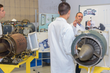 Men looking at aircraft turbine