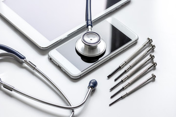 diagnostic of gadgets on white background with stethoscope