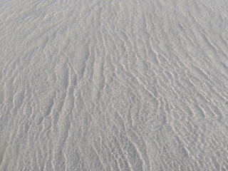 Water with sunbeams over sandy sea bottom