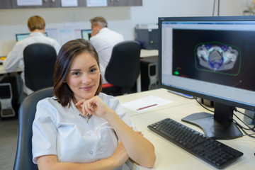 Portrait of female technician by computer