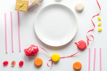 Gift box with colorful party items white background top view