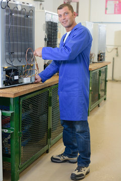 Repairman working on fridge