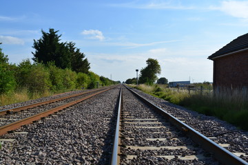 Fototapeta na wymiar Train tracks countryside straight empty