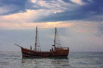 Fototapeta na wymiar Wooden boat on a sunset background 