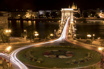Fototapeta na wymiar Long-exposure night shot of a square, a bridge and their traffic
