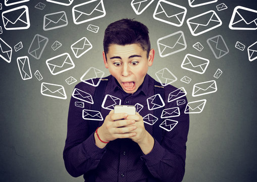 shocked man receiving messages from smartphone email icons flying away