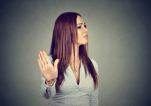 annoyed angry woman giving talk to hand gesture