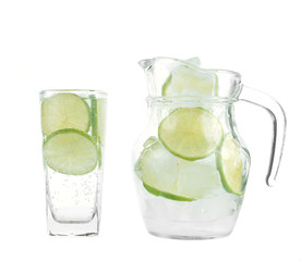Full glass of fresh cool tonic with lime fruits isolated on whit