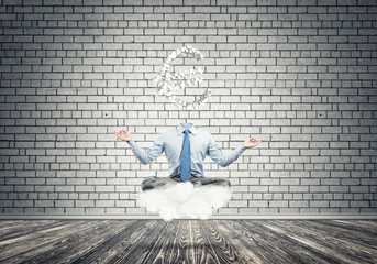 Headless meditating businessman