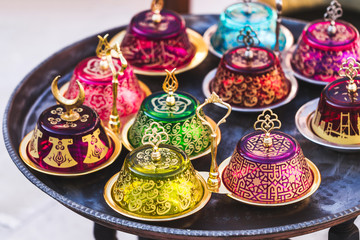 Stack of handmade multicolor Turkish dishes on the market. Vinta