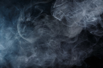Abstract smoke Weipa. Personal vaporizers fragrant steam. The concept of alternative non-nicotine smoking. Blue smoke on a black background. E-cigarette. Evaporator. Taking Close-up. Vaping.