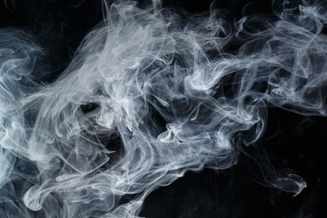 Abstract smoke Weipa. Personal vaporizers fragrant steam. The concept of alternative non-nicotine smoking. Blue smoke on a black background. E-cigarette. Evaporator. Taking Close-up. Vaping.