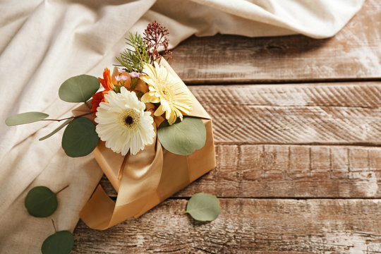 Box decorated with flowers on wooden background