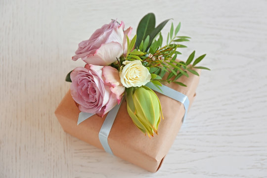 Box decorated with flowers on light background