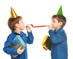 Cute birthday boys with party whistles and presents on white background