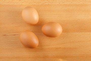 Home cooking concept, fresh organic eggs on wooden board backgro