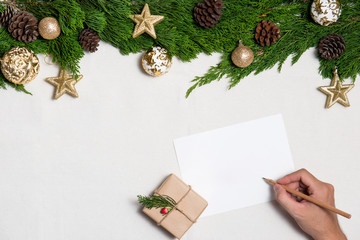 Fototapeta premium Hand writting Christmas Card on Xmas background. Top view.