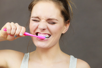 Woman brushing cleaning teeth