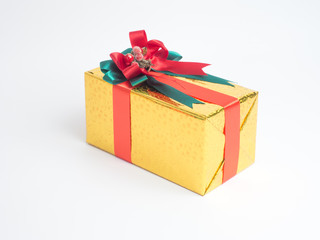 color box with red ribbon white background with small lighting  on wooden table for Christmas and The New Year .