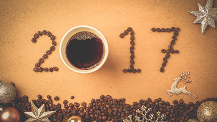 2017 coffee bean text and christmas decoration on red craft paper for new year concept background

