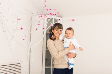 happy family. Mother and baby playing and smiling indoor