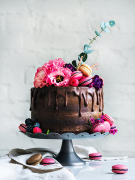 Chocolate Wedding cake with flowers macarons and blueberries