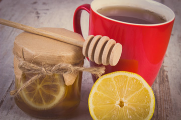 Vintage photo, Fresh lemon with honey and cup of tea on wooden table, healthy nutrition
