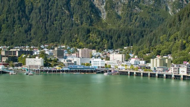 Downtown Juneau Alaska City at Base of Mount Juneau on a Sunny Summer Day with Green Forest Trees Behind City Buildings