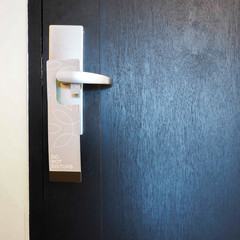 Please do not disturb wooden hanger, hanging on a handle of wood