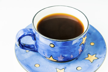 Coffee cup saucer blue stars black coffee white bground