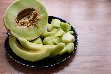 chopped ripe melon slices and served on a black plate