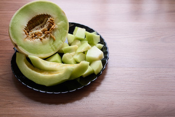 chopped ripe melon slices and served on a black plate