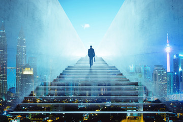 Rear view of a businessman climbing stairs to get to a large city center. Concept of success and...