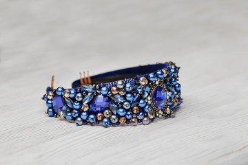 Fashionable jewelry hair decoration rim on a white wooden background