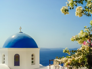 Fototapeta na wymiar Blue dome of St. Nicholas church in Oia Santorini
