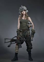 Naklejka premium Very beautiful girl - soldiers - the future, in a helmet and with an unusual gun in his hand, after the fight.