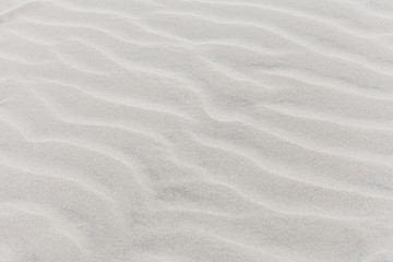 Fototapeta na wymiar Waves on beach of gray sand