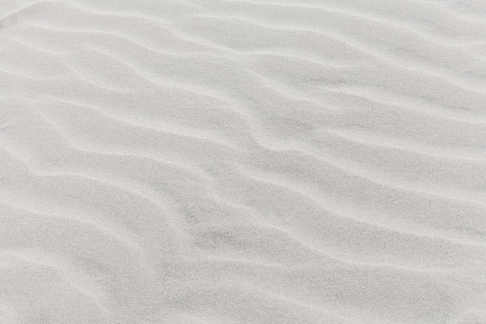 Waves on beach of gray sand