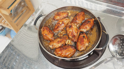 Fototapeta premium Chicken wings cooking fried pan and equipment